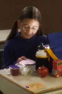 Girl eating lunch at desk