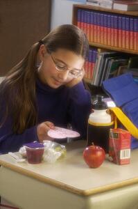 Girl eating lunch at desk