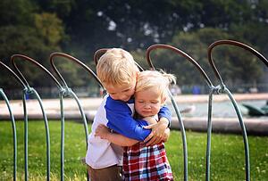 Brother and sister hugging