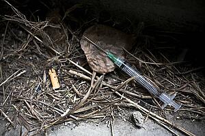 Syringe and needle on street