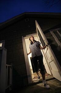Woman stepping out of a house