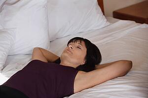 Woman lying on bed