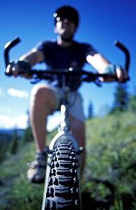 Cyclist on mountain bike on hillside