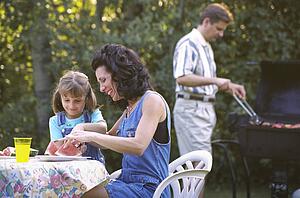 Mother and daughter eating watermelon at picnic