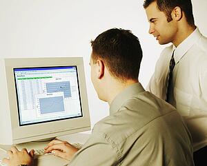 Two men working on computer