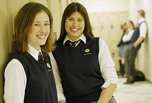 Female students standing in hallway