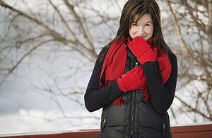 Woman with a red scarf and mittens