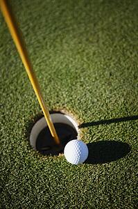 The ball next to the hole