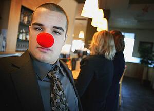 Businessman wearing red nose