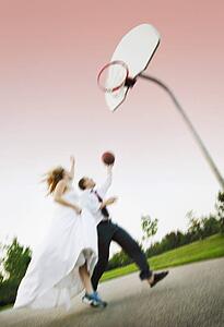 Bride and groom play basketball