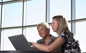 Two women looking at personal computer