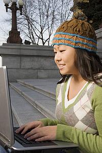 Girl working on computer outside