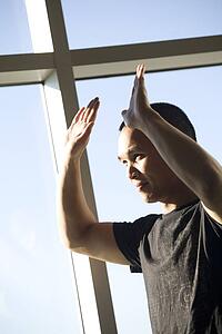 Man with his hands raised