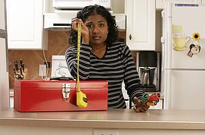 Woman looking hopeless with toolbox and tools