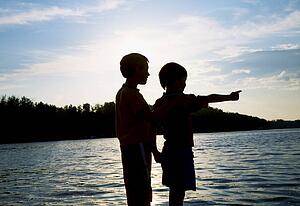 Silhouette of children by a beach