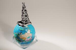 Globe in ice with oil drilling rig