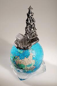 Globe in ice with oil drilling rig