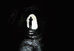 Person walking out of a tunnel