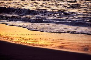 Sunset reflected on wet sand