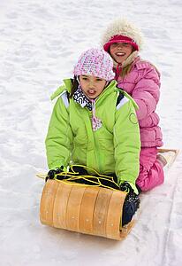 Children tobogganing 
