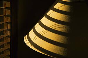 Shadow of blind on lamp shade