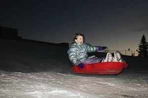 Child in sled at night