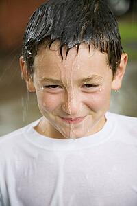 Boy with water dripping from head
