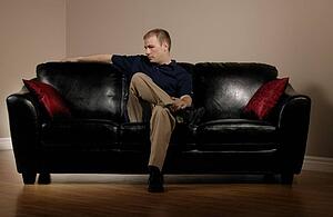 Man sitting on couch alone