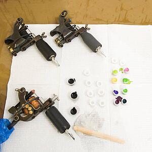 Still life of tattoo tools and inks.