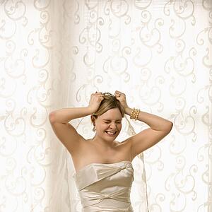 Bride pulling at hair and veil