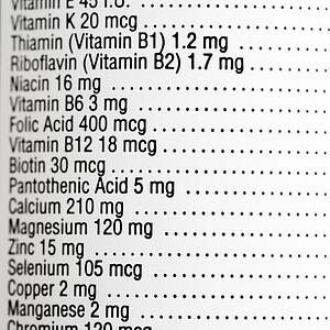 Close up of supplement label with amount of vitamins.
