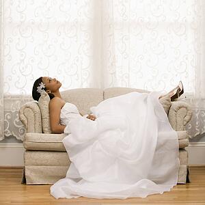 Bride lying on love seat