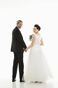 Groom and bride holding hands