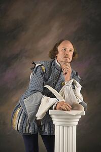 William Shakespeare in period clothing leaning on column with hand to chin in thoughtful expression