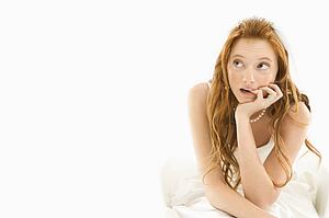 Bride biting her finger and looking off to the side 