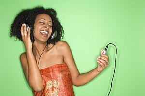 Woman listening to music through headphones