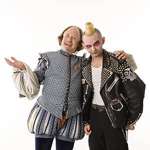 William Shakespeare smiling with arm around gothic punk young man.