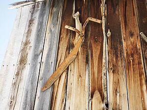 Rusted tools on side of barn.