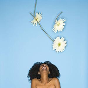Woman tossing fake flowers in the air
