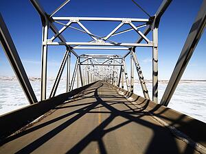 Bridge with unique shadows over frozen water in Midwestern, USA.