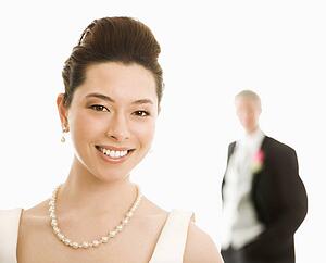 Bride in foreground and groom in background