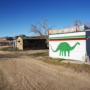 Small building iwht dinosaur painted on side in Crescent Junction, Utah. 