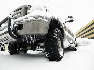 Big SUV covered in snow and ice