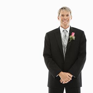 Portrait of Caucasian male in tuxedo with boutonniere.