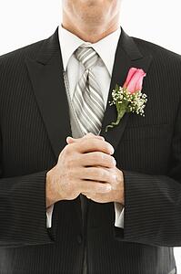 Close up of groom with clenched fists