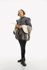William Shakespeare in period clothing holding feather pen looking at viewer.