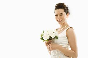 Portrait of Asian bride with bouquet.