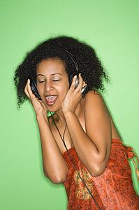 Woman listening to music through headphones