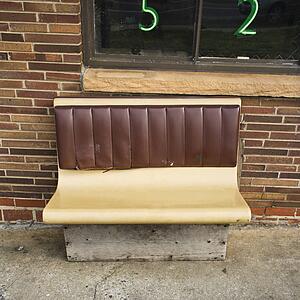 Bench seat outside brick building.