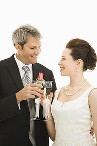 Groom and bride toasting with champagne glasses.